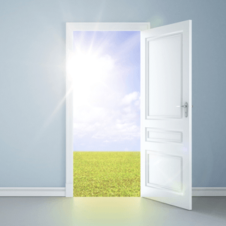 A door leading into a sunny field